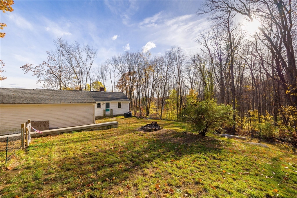 1350 Thresher Road Hardwick, MA 01037 - Photo 34 of 37 a view of a lake with a building in the background