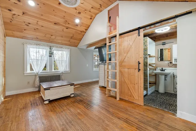 a living room with hard wood floors and a ceiling fan