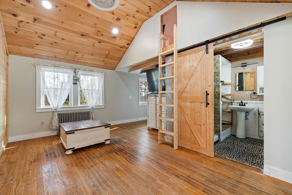 1350 Thresher Road Hardwick, MA 01037 - Photo 6 of 37 a living room with hard wood floors and a ceiling fan