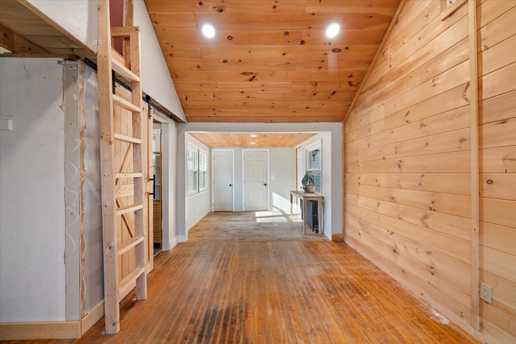 1350 Thresher Road Hardwick, MA 01037 - Photo 9 of 37 a view of a hallway with wooden floor and staircase