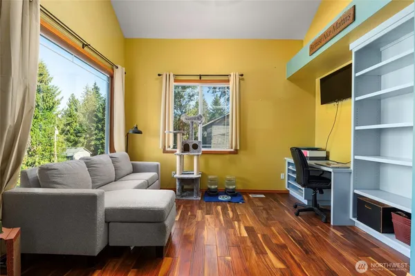 a living room with furniture and wooden floor