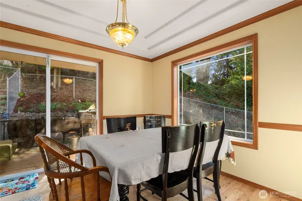 a view of a dining room with furniture wooden floor and a chandelier