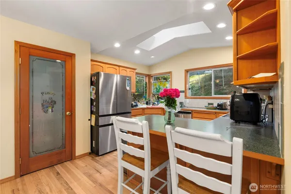 a kitchen with stainless steel appliances granite countertop a refrigerator and a stove top oven