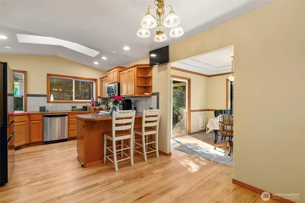 a view of a dining room with furniture a chandelier and wooden floor