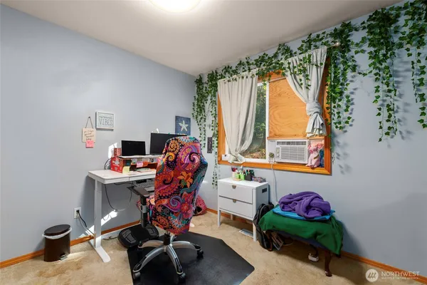 a view of a workspace with furniture and a window