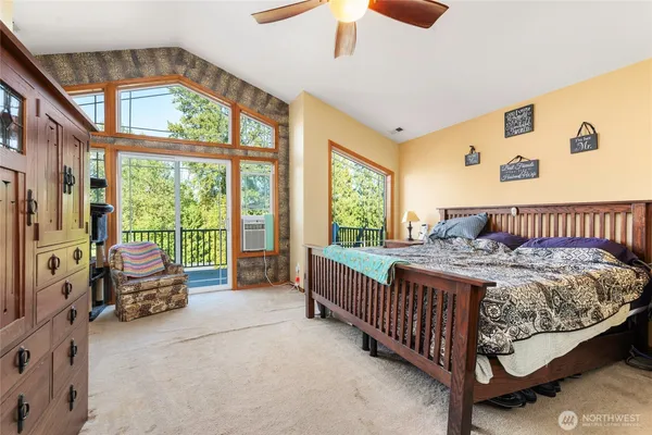 a bedroom with a bed and a large window
