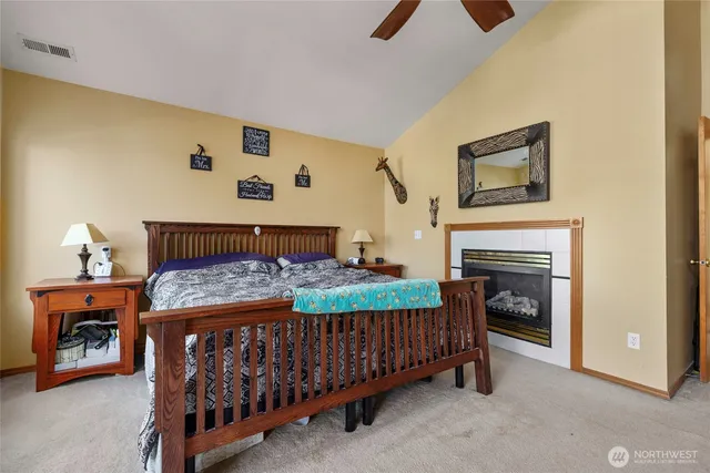 a bedroom with a bed and a fireplace