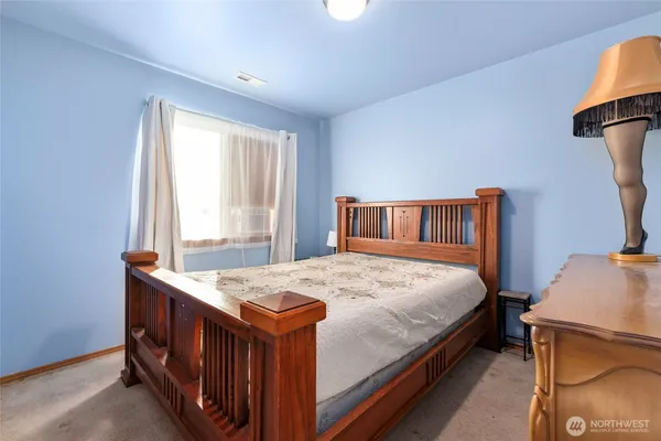 a bedroom with a bed and a dresser in it