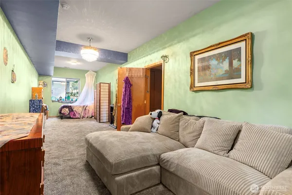 a living room with furniture and a large mirror