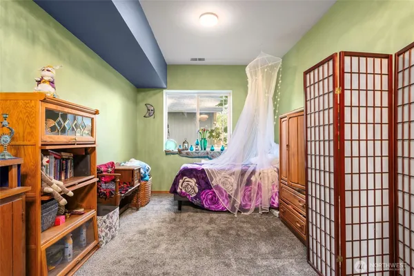a bedroom with furniture and a book shelf