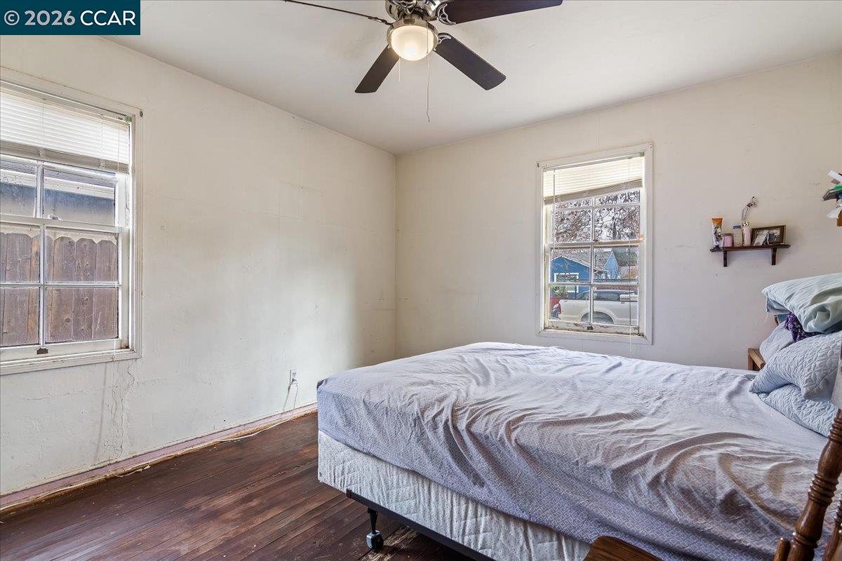 178 Army Street Pittsburg, CA 94565 - Photo 16 of 24 a bedroom with a bed and wooden floor