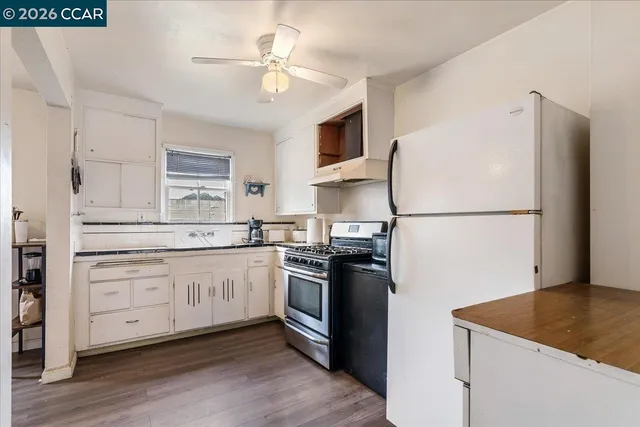 a kitchen with stainless steel appliances granite countertop a refrigerator a sink dishwasher a stove and a refrigerator