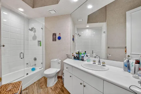 a bathroom with a sink a toilet and a large mirror