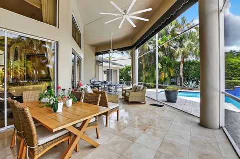 a balcony with furniture and a potted plant