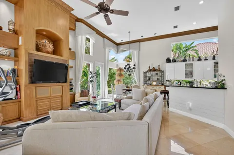 a living room with furniture tv and a flat screen tv