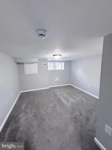 a view of an empty room with windows