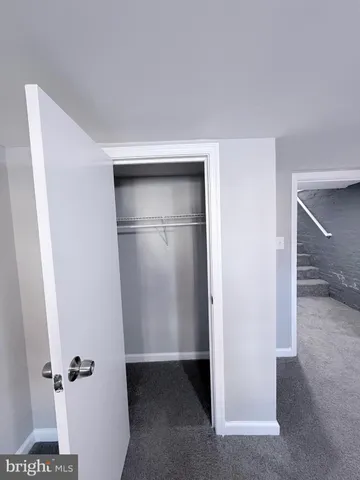 a white toilet sitting next to a bath tub and a shower