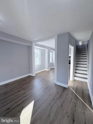 a view of wooden floor and windows in an empty room