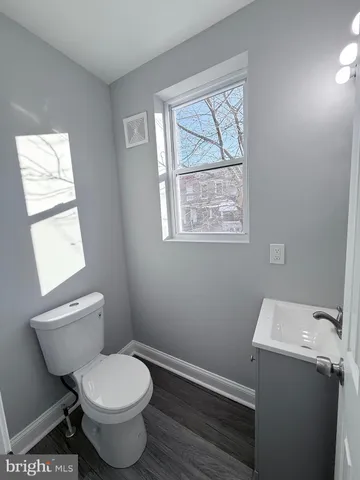 a bathroom with a toilet sink and window