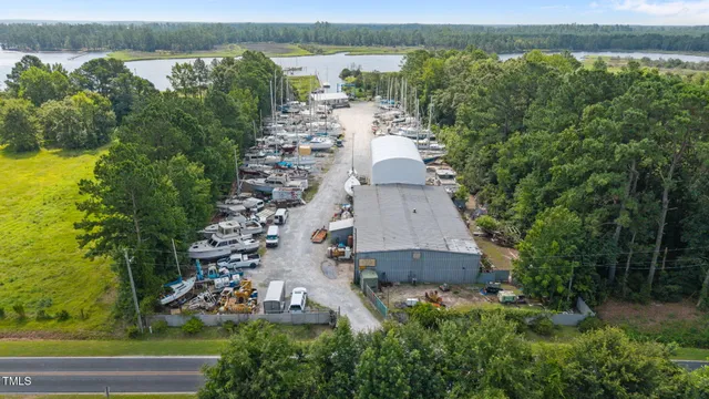 an aerial view of a house with a yard and lake view