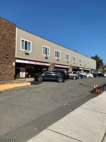 a front view of a building with cars