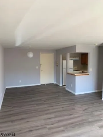 a view of kitchen with microwave and cabinets