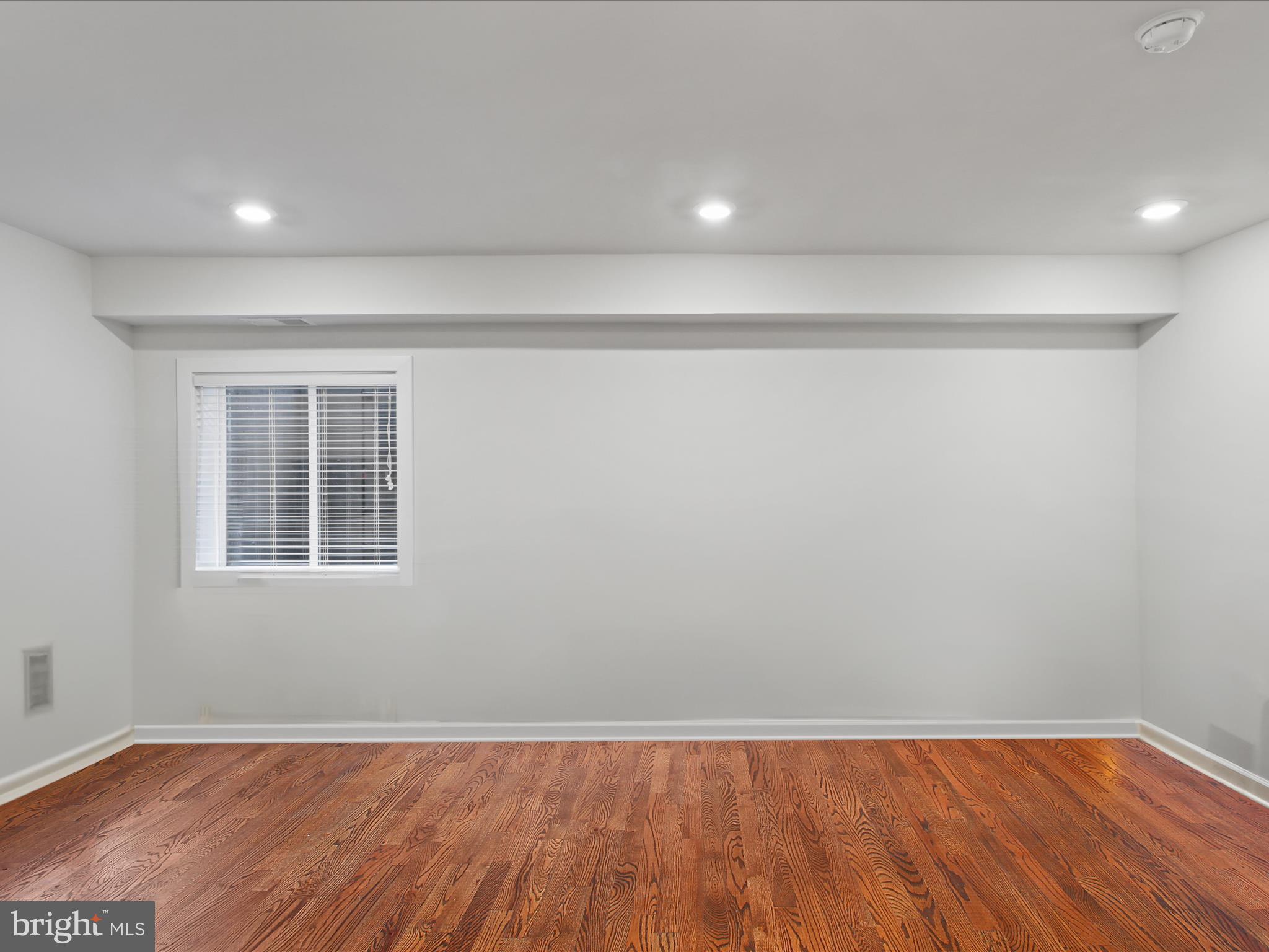 5742 10th Road North Arlington, VA 22205 - Photo 33 of 44 a view of an empty room with wooden floor and a window