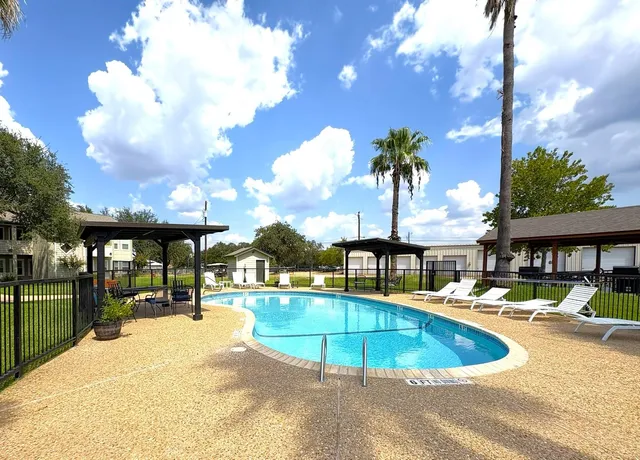 a swimming pool with outdoor seating and yard