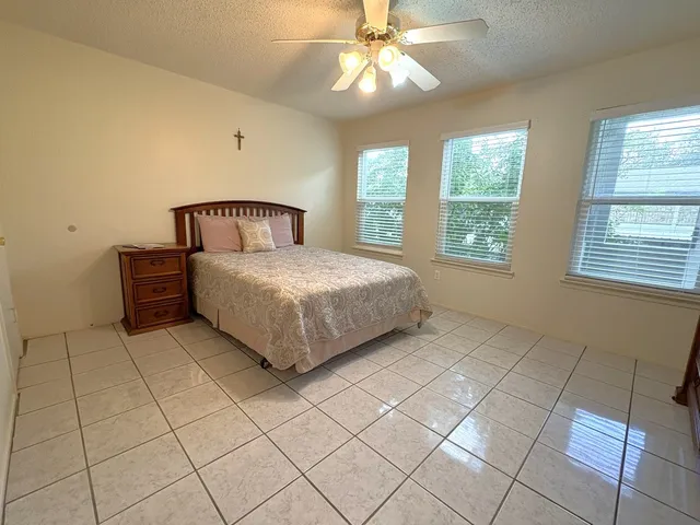 a white toilet sitting next to a bath tub