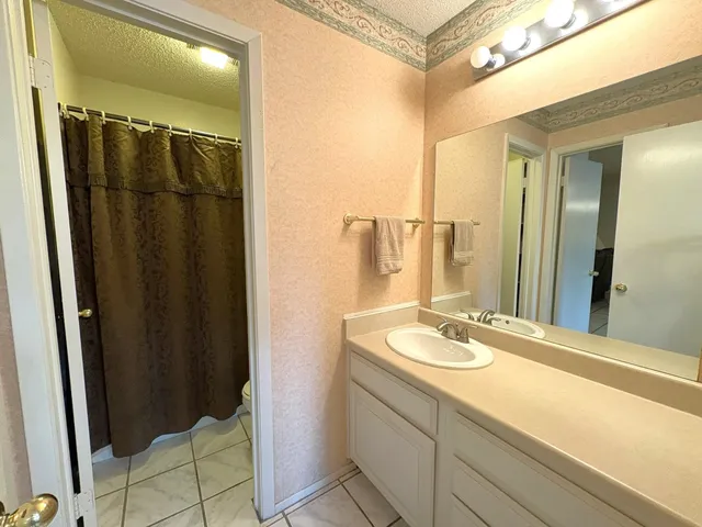 a view of a swimming pool with a lawn chairs under an umbrella