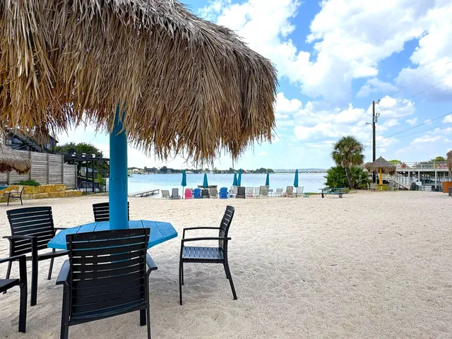 an outdoor sitting area with couch and wooden fence