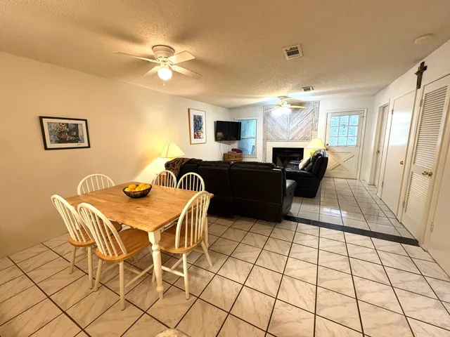 a kitchen with granite countertop a refrigerator and a stove top oven
