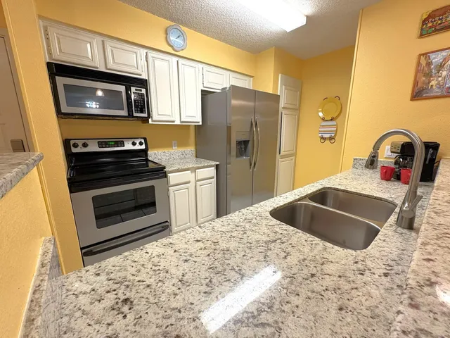 a view of a kitchen and a sink