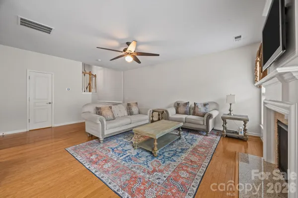 a living room with furniture fireplace and a table