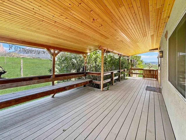 a view of a balcony with wooden floor