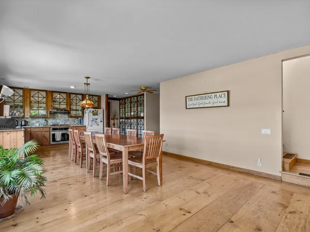 a dining room with furniture and wooden floor