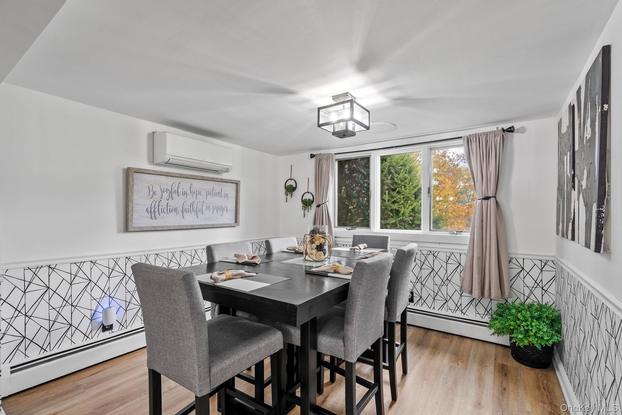 168 Fostertown Road Newburgh, NY 12550 - Photo 14 of 38 Dining area featuring wainscoting, baseboard heating, light wood-style floors, and a wall unit AC