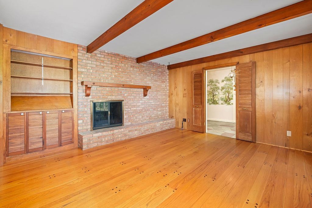3723 Brookview Road Rockford, IL 61107 - Photo 16 of 44 a view of empty room with wooden floor and fireplace