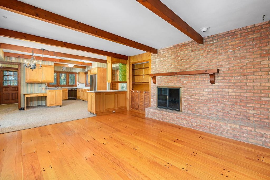 3723 Brookview Road Rockford, IL 61107 - Photo 17 of 44 a view of an empty room with wooden floor and a fireplace