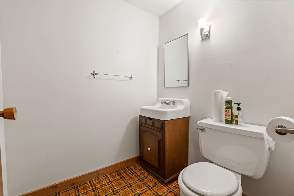 3723 Brookview Road Rockford, IL 61107 - Photo 37 of 44 a bathroom with a toilet a sink and mirror