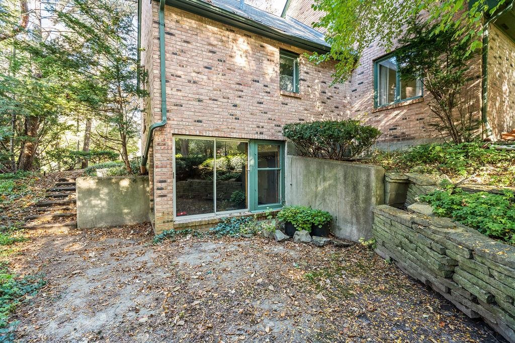 3723 Brookview Road Rockford, IL 61107 - Photo 38 of 44 a view of a brick house with a large windows and large trees