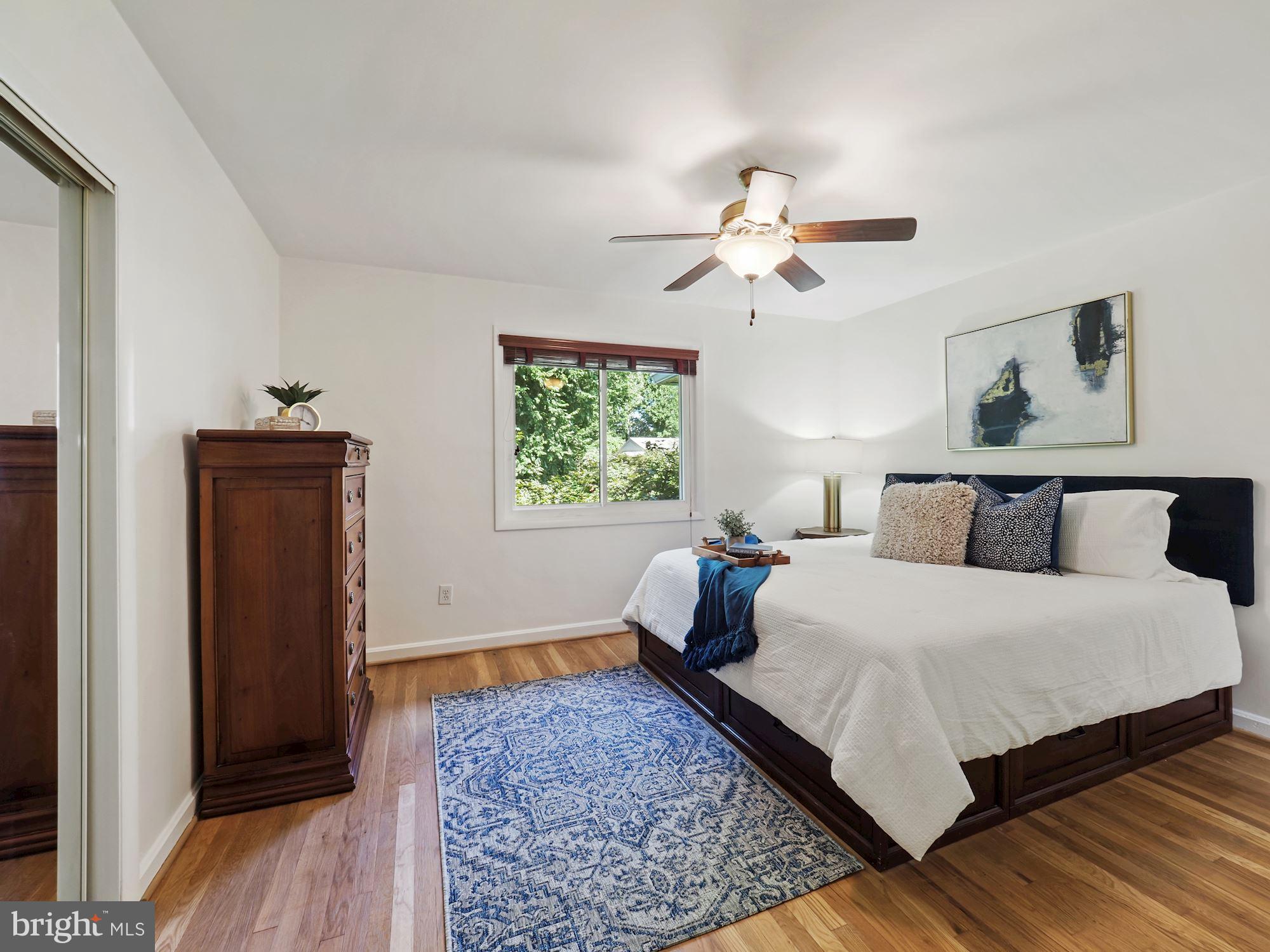 5343 Pooks Hill Road, Unit 40353 Bethesda, MD 20814 - Photo 14 of 57 a bedroom with a bed and a chandelier