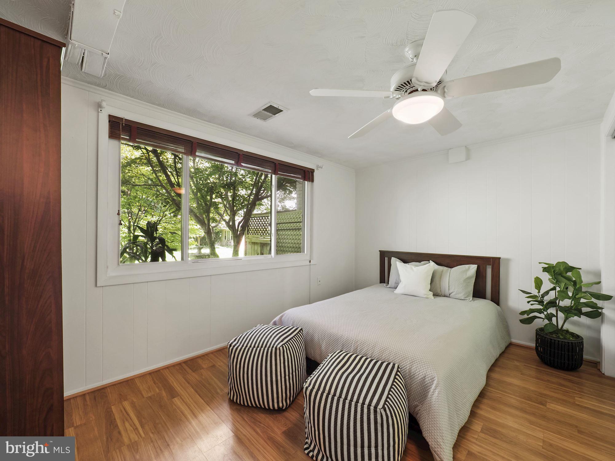 5343 Pooks Hill Road, Unit 40353 Bethesda, MD 20814 - Photo 21 of 57 a bedroom with a large bed and a chandelier