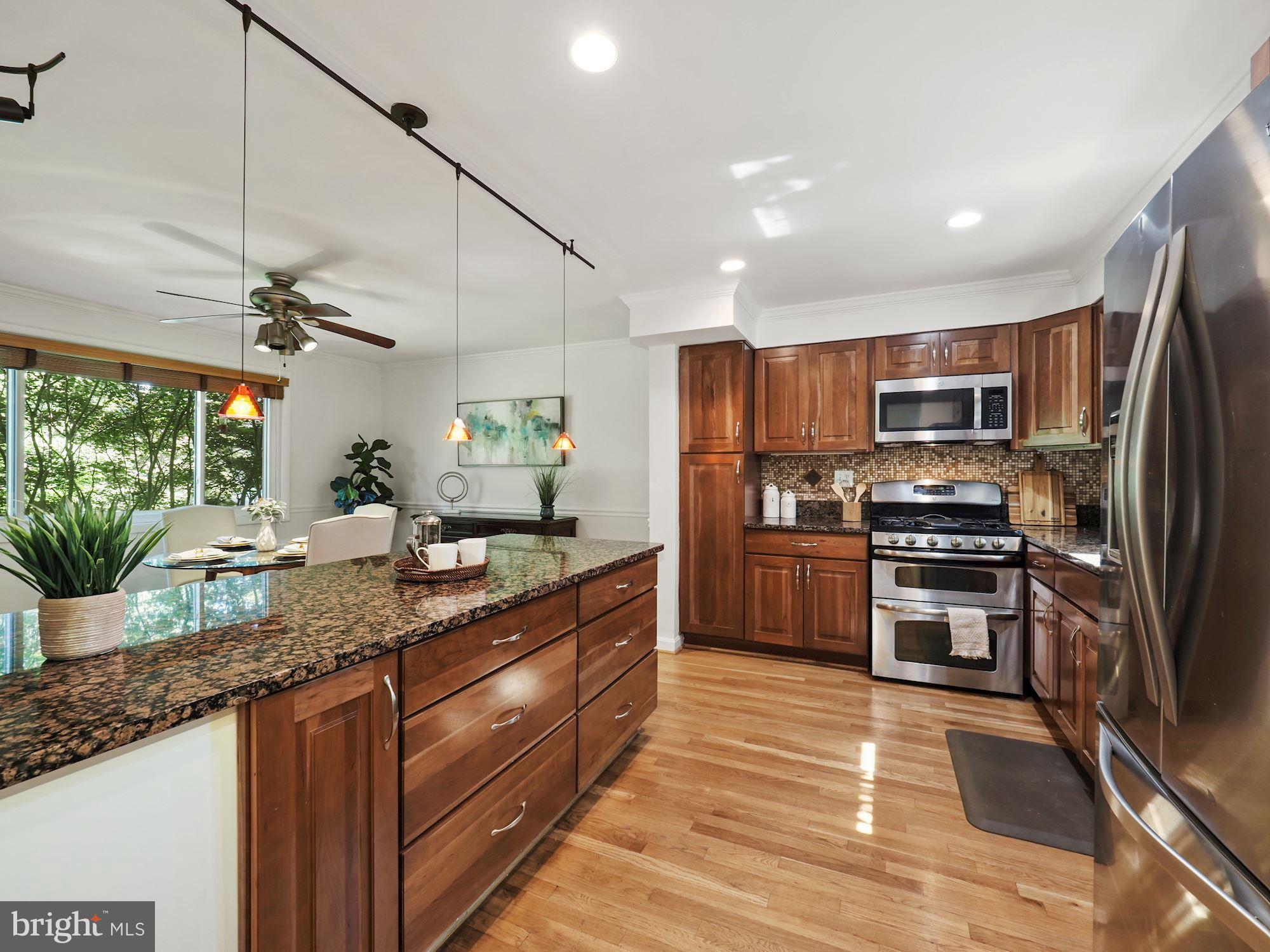 5343 Pooks Hill Road, Unit 40353 Bethesda, MD 20814 - Photo 10 of 57 a kitchen with granite countertop stainless steel appliances and counter space