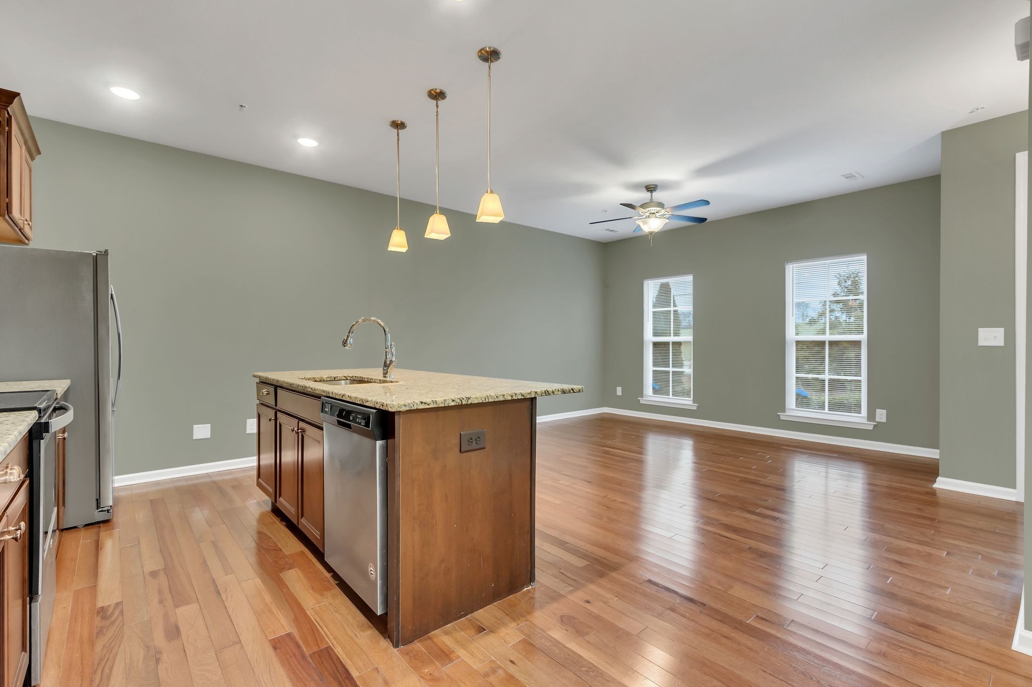 305 Dursley Lane Spring Hill, TN 37174 - Photo 11 of 25 a kitchen with stainless steel appliances granite countertop a sink a stove a refrigerator and a oven with wooden floor