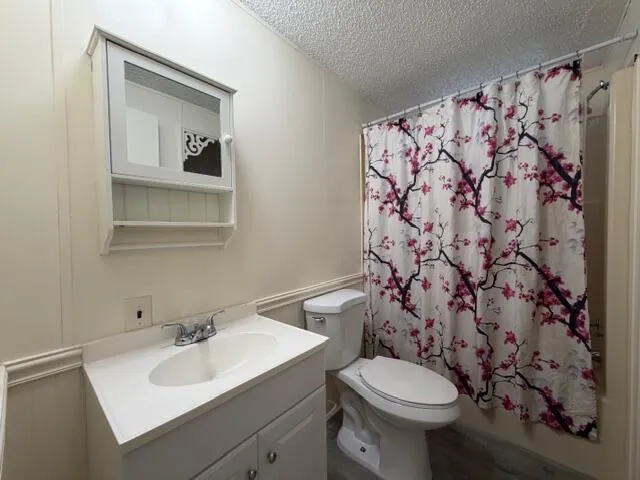 a bathroom with a sink toilet and a mirror