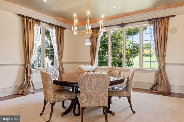 a kitchen with granite countertop white cabinets and window