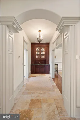 a kitchen with a stove a counter space a sink appliances and cabinets