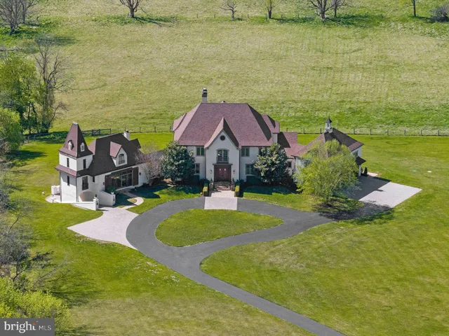 a aerial view of a house with swimming pool and a yard