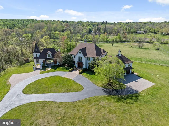 an aerial view of residential houses with outdoor space and swimming pool